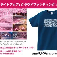 2021-22年に実施予定の弘前公園外濠「冬に咲くさくらライトアップ」のクラウドファンディングの返礼品として、cogin+TとタイアップしたTシャツを作成しました！ ・今回のクラウドファンディングでのみ入手可能なオリジナルデザインです。 ・イベントやネットショップでの購入による寄付も可能です。 （※通販は10月下旬開始予定　※11月15日までの期間限定販売） ・「さくら」と「カチャラズ」の図案を組み合わせ、雪の中に咲く桜を表現したデザインです。 ・古作こぎん刺しの配色「紺地に白」をイメージしたカラーリング。 支援額 5,000円（Tシャツ 2,000円 + 寄付 3,000円）